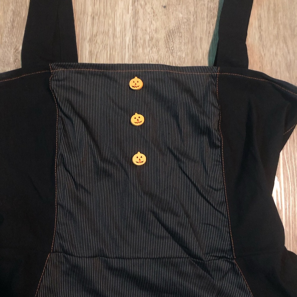 Black with pinstripes and orange stitching.fit and flair dress. Pumpkin buttons